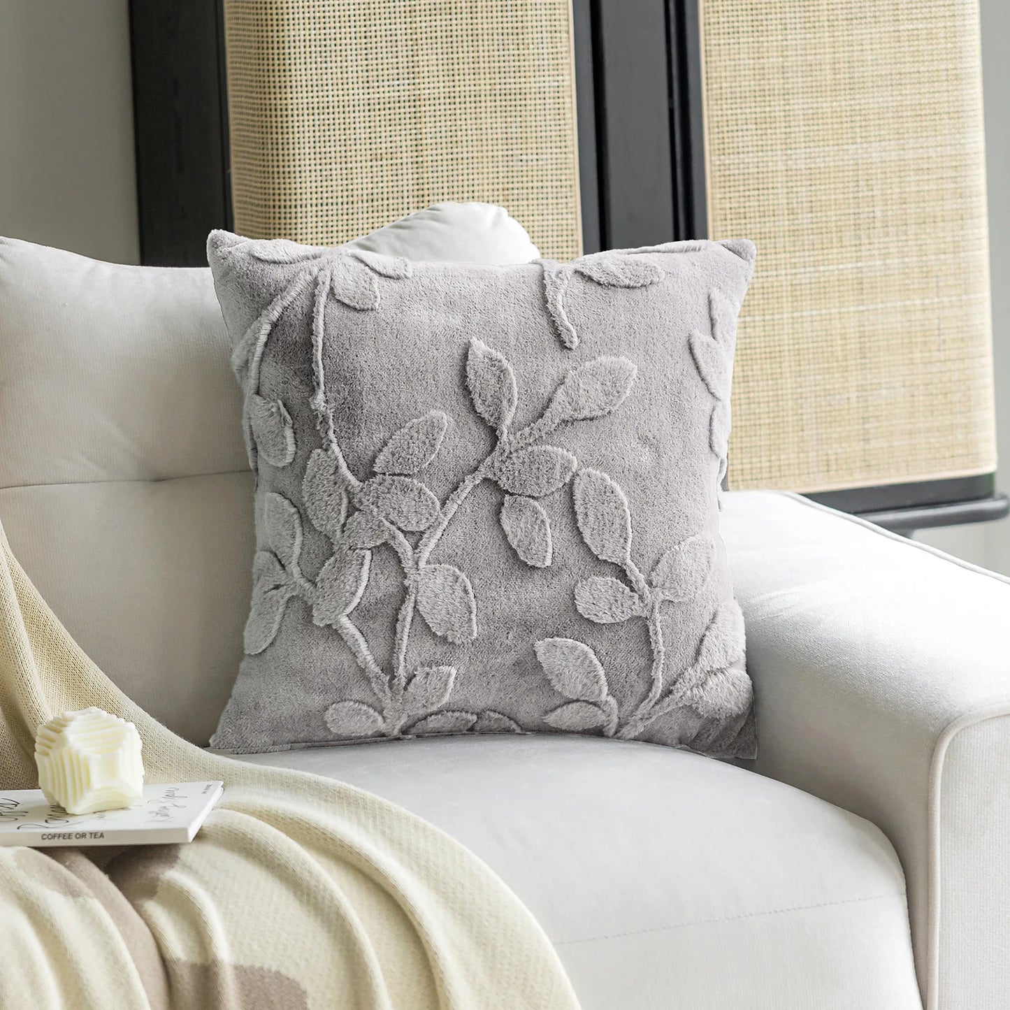 Light grey decorative cushion cover showing soft plush fabric texture