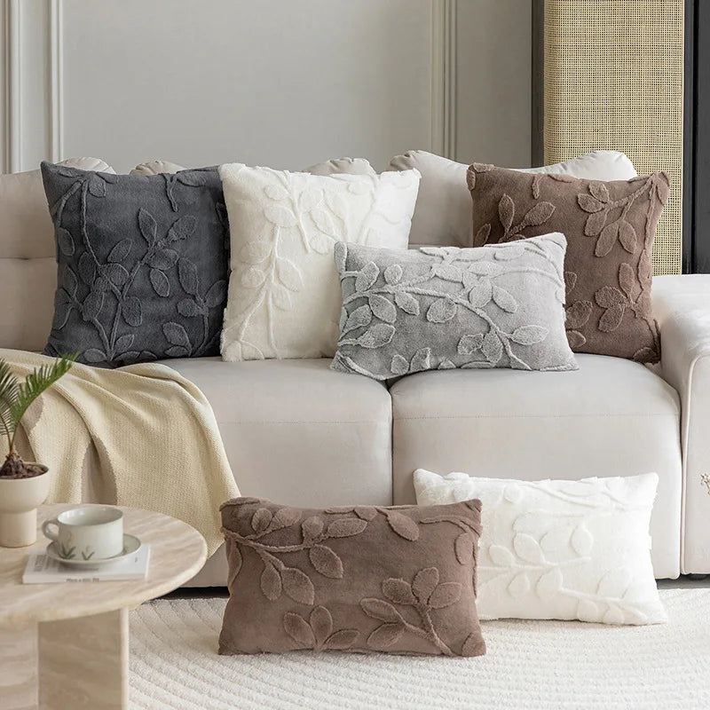 Mandee jacquard throw pillow covers in assorted neutral colors displayed on beige sofa