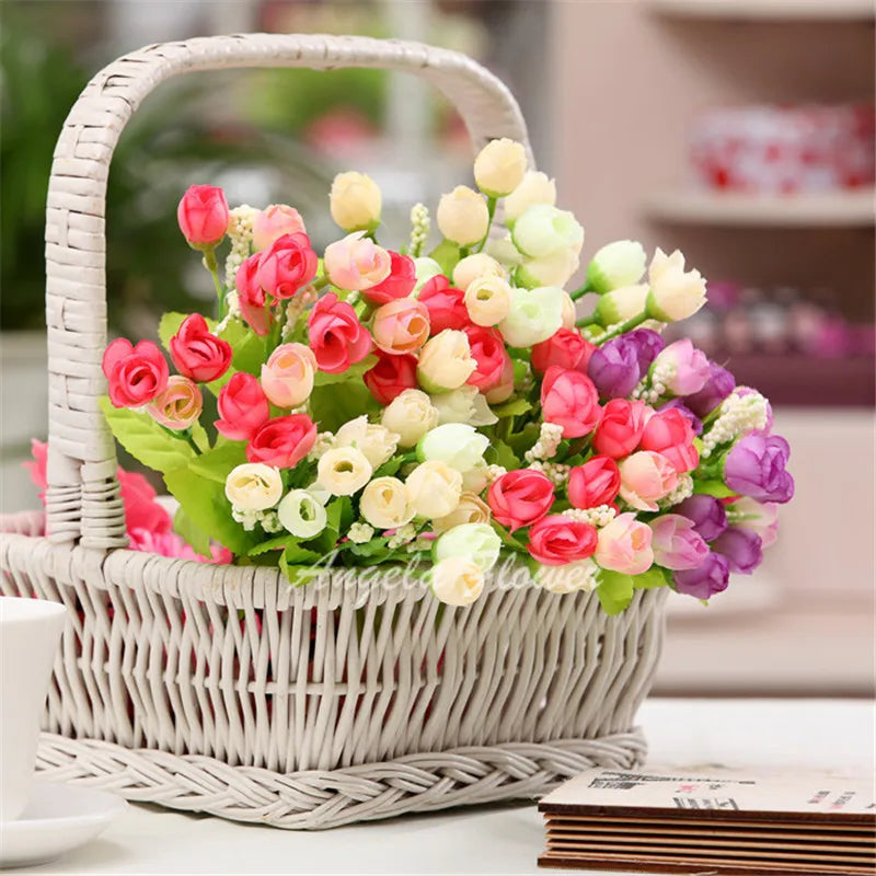 Wicker basket arrangement with mixed color small bud roses for table decor