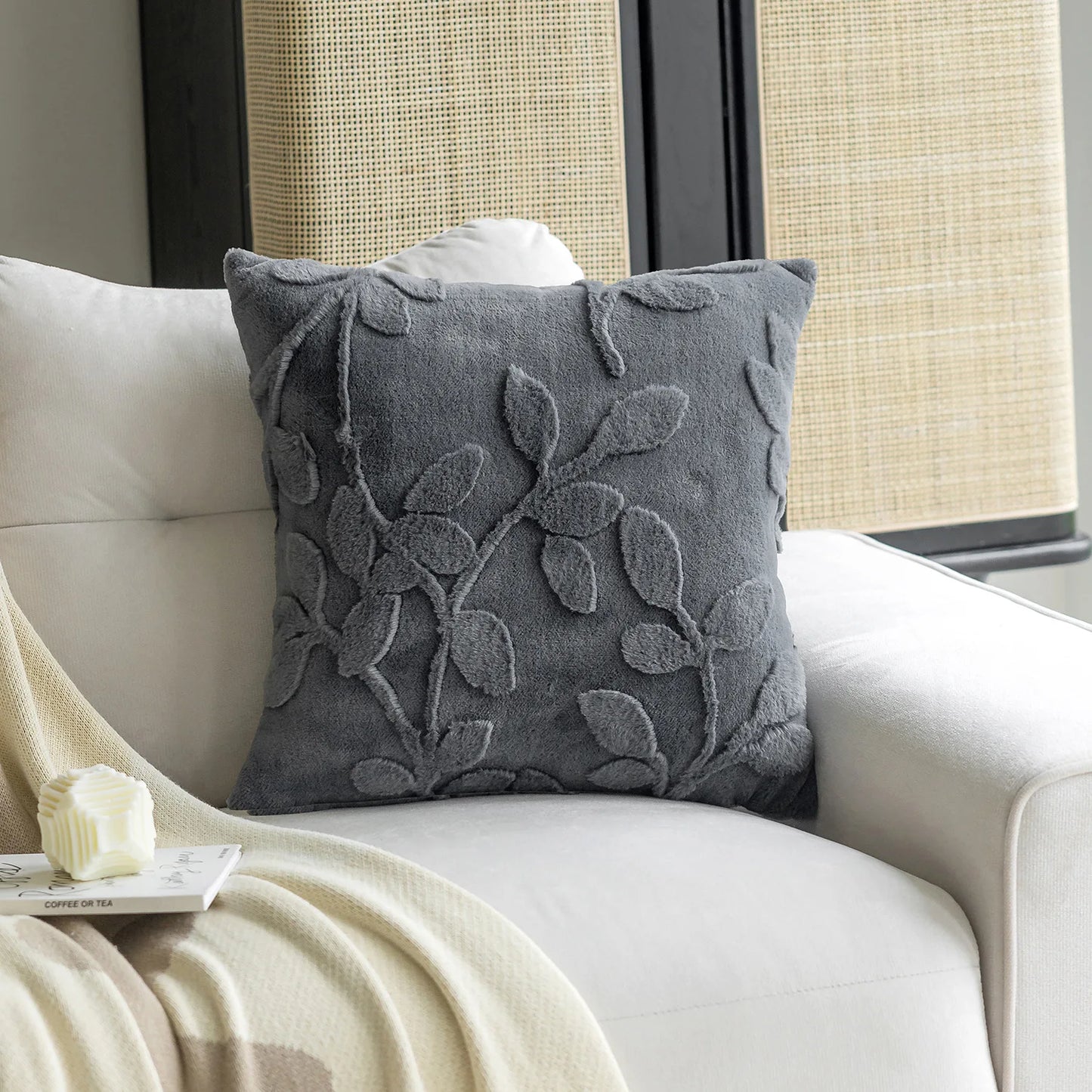Dark grey decorative cushion cover showing soft plush fabric texture