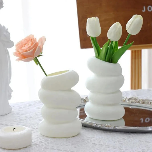 Modern white twisted vase holding flowers