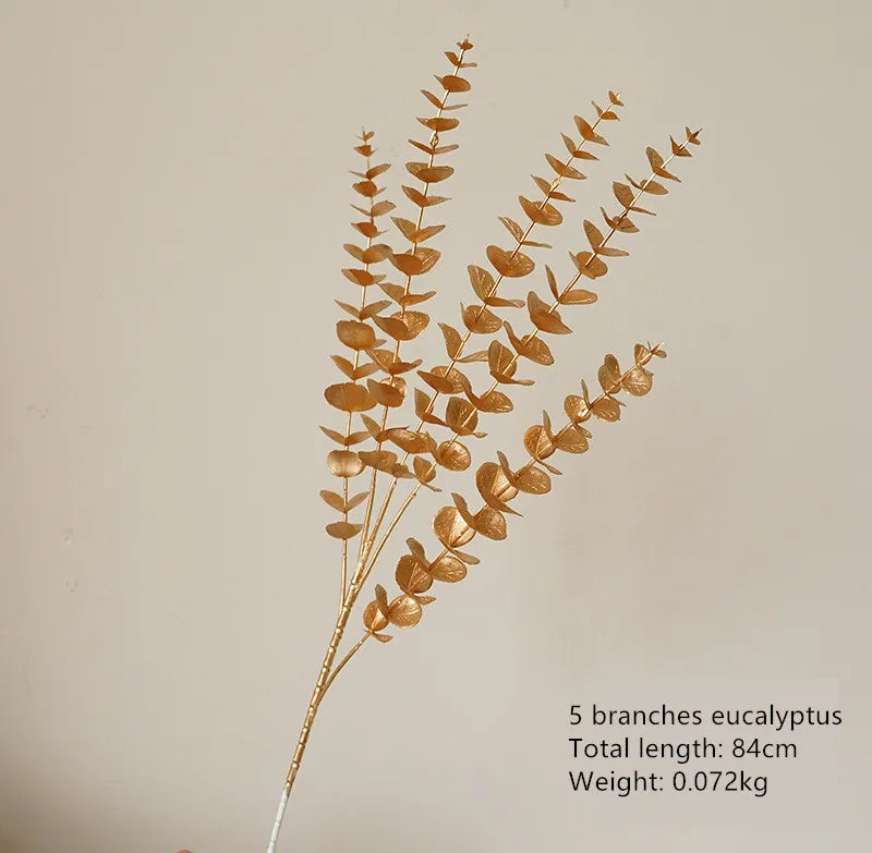 Golden eucalyptus leaves decorative display - festive artificial botanical arrangement
