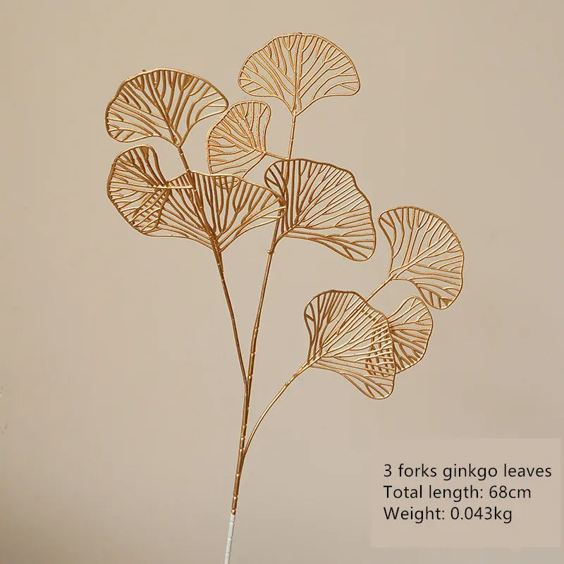 Artificial golden ginkgo leaves close-up - realistic metallic finish botanical decor