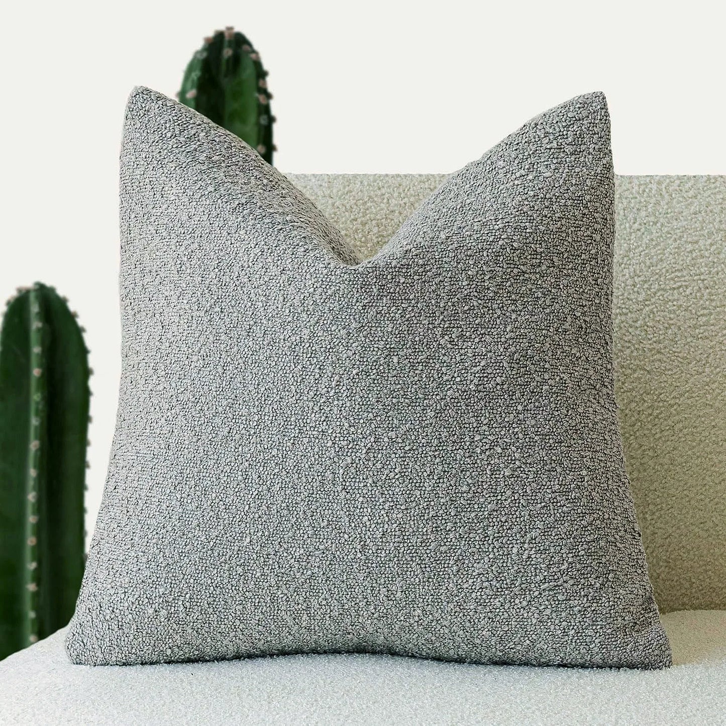 Xoco light grey teddy fleece pillow cover styled on modern sofa in contemporary living room